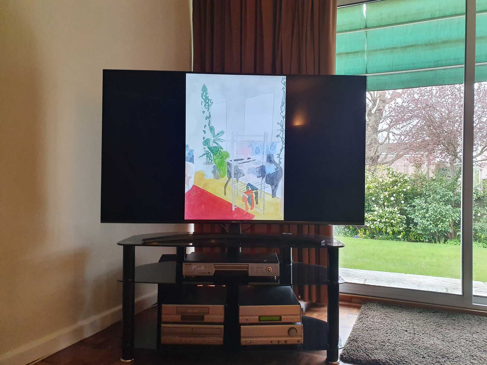 An image of a painting by the artist Alice Mendelowitz is displayed on a TV in the corner of a room, next to a glass sliding door that leads to a garden.